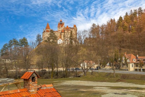 Beautiful panoramic view of Dracula Bran medieval castle and blue cloudy sky, Transylvania,