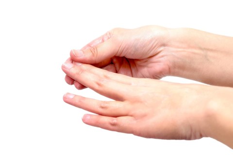 Close-up of female hands while applying moisturizing lotion in order to repair damaged and dry