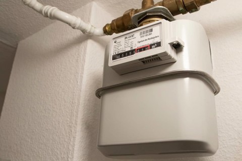 Symbolic image of energy costs in the household, natural gas, analogue gas meter in a flat,
