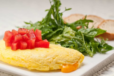 Home made omelette with cheese tomato and rucola rocket salad arugola