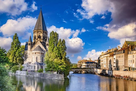 METZ, FRANCE - AUG 5, 2022: The old town architecture of Metz at the Moselle river, France, Europe