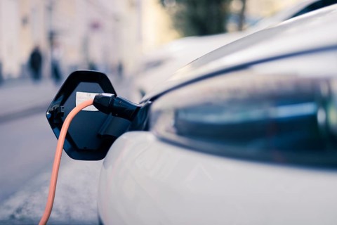 Electric car recharging with charge cable and plug leading to charge point