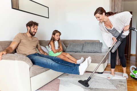 Woman vacuuming carpet