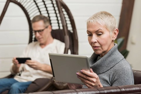 Senior couple looking through their devices