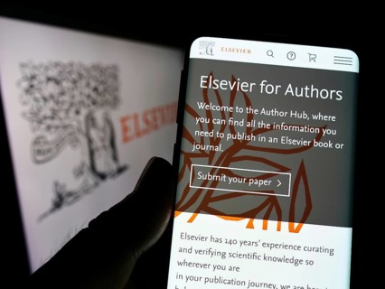 Stuttgart, Germany, 07-31-2022: Person holding smartphone with website of academic publishing