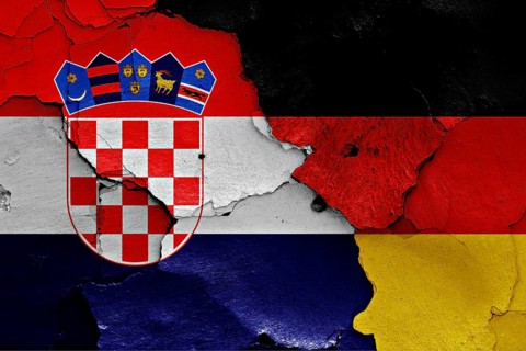 Flags of Croatia and Germany painted on cracked wall