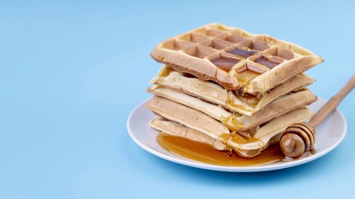 High angle honey covered stacked waffles plate with copy space