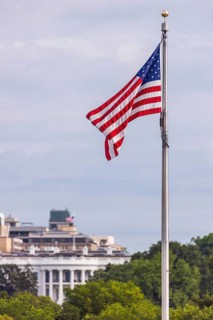 American Flag with the White House in the background