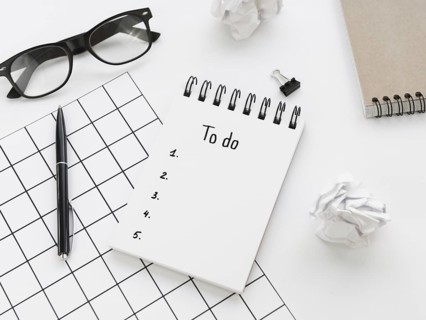High angle list notepad with glasses pen