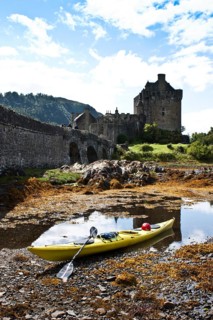 Kayak in front of Eilean Donan Castle, Scotland, United Kingdom, Europe