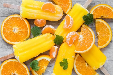 Top view yummy popsicles with orange mint