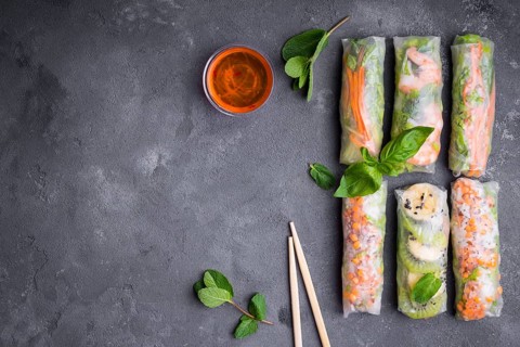 Fresh assorted spring rolls set background. Handmade asianChinese spring rolls, sauce, chopsticks.