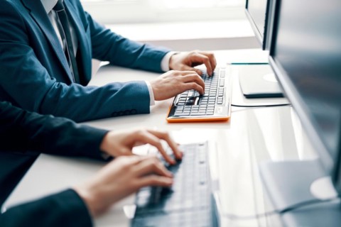 Business people working on laptop. People hands typing on laptop keyboard