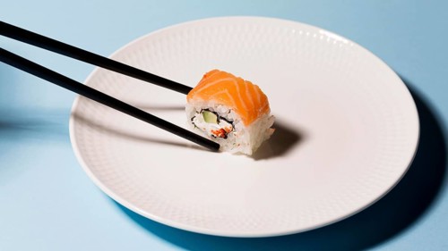 Plate with sushi roll chopsticks