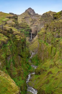 Mountain landscape with green canyon, waterfall and river in Múlagljúfur Canyon, Sudurland,