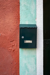 Letterbox on a red-blue-white house wall, colourful houses on the island of Burano, Venice, Veneto,