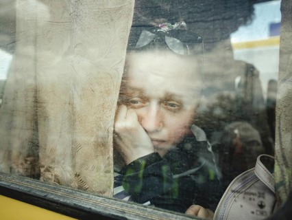 Arrival of refugees from occupied Kherson in the car park of a shopping centre, the two buses were