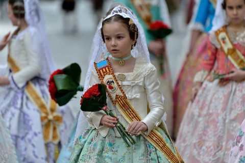 Fallas festival, girls in a traditional costume during the parade in the Plaza de la Virgen de los