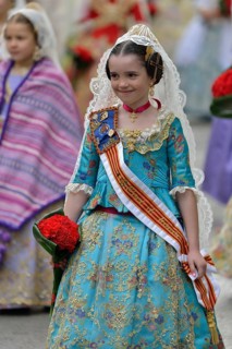 Fallas festival, girl in a traditional costume during the parade in the Plaza de la Virgen de los