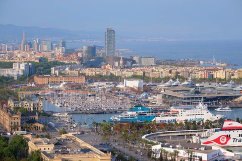 BARCELONA, SPAIN, APRIL 15, 2019: Aerial view of Barcelona city skyline with city traffic and port
