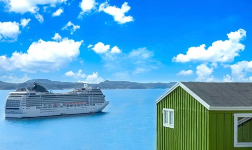 Cruise ship visit to Greenland city Qarqotoq with colored houses located near fjords and icebergs