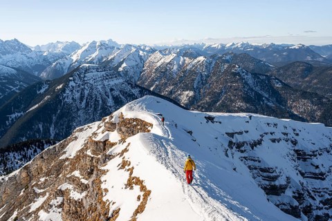 Two ski tourers at the summit of Schafreuter, view of snowy mountain panorama, Karwendel, Tyrol,