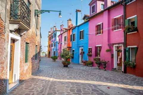 Colourful houses with flowers, colourful house facades, alleys on the island of Burano, Venice,