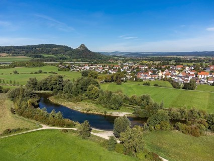 The Radolfzeller Aach with the village of Hausen an der Aach, on the horizon the Hegau volcano