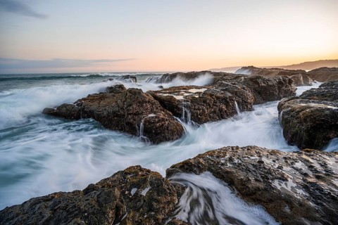 Waves washing over rocks by the sea, long exposure, coastal landscape at sunset, Playa Cocalito,