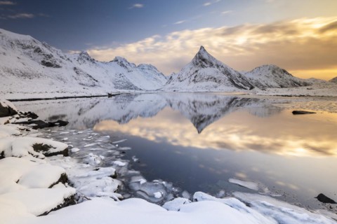 Snowy landscape with mountains and fjord, Volandstinden mountain, Fredvang, Flakstadøya, Lofoten,
