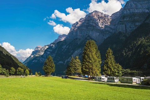 Vorauen campsite on the shores of Lake Klöntal with the Glärnisch Group rising up to 2915 metres,
