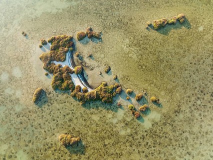 Islands and conspicuous patterns at the shallow lagoon Salinas de Cerrillos, aerial view, drone