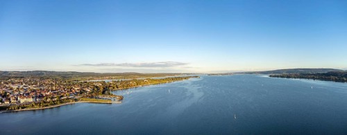 Aerial view of Lake Constance with the town of Radolfzell and the Mettnau peninsula, on the horizon
