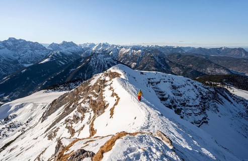 Ski tourers at the summit of Schafreuter, view of snow-covered mountain panorama, Karwendel, Tyrol,