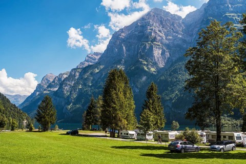 Vorauen campsite on the shores of Lake Klöntal with the Glärnisch Group rising up to 2915 metres,