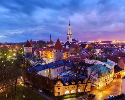 Aerial view of Tallinn Medieval Old Town with St. Olaf's Church and Tallinn City Wall illuminated