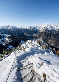 Hiking trail on the snow-covered summit of the Jenner with viewing platform in autumn, view of the