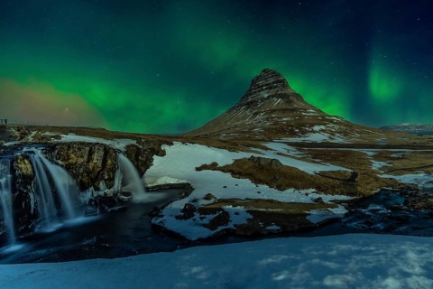 Beautiful Northern Lights on the picturesque Kirkjufell mountain in winter Iceland. Aurora Borealis