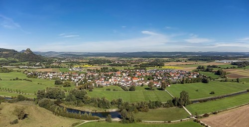 The Radolfzeller Aach with the village of Hausen an der Aach, on the horizon the Hegau volcano