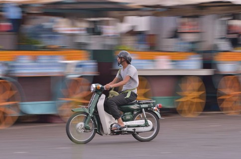 Moped rider at Djemaa el Fna market square, historic center, Marrakesh, Marrakesh-Tensift-El Haouz