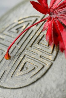 Japanese Maple leaf and Japanese emblem in stone, esotericism, symbol Japanese maple, leaf, and