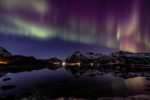 Northern lights over fjord, steep mountains, winter, aurora borealis, Flakstadoya, Lofoten, Norway,