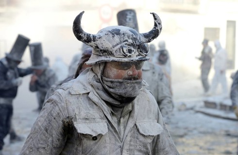 Man wearing viking helmet, Els Enfarinats flour fight, rebels, armed with flour, eggs and