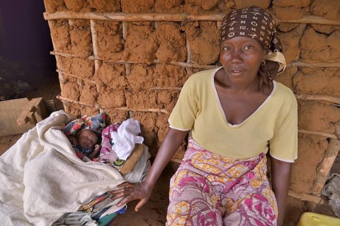 Woman with a child sitting in front of her hut, near Kent, Western Area Region, Sierra Leone,