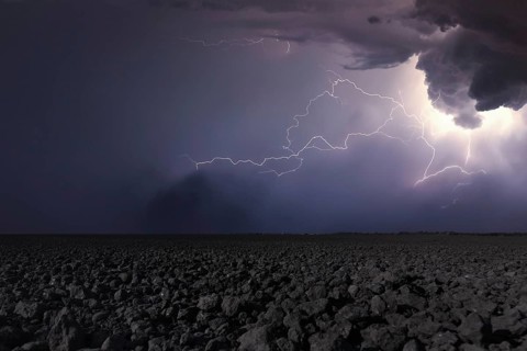 Thunderstorm with lightning in plowed field. Thunderstorm background