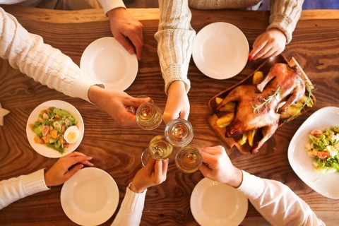 Christmas dinner with roast duck and champagne on wooden table. Top view