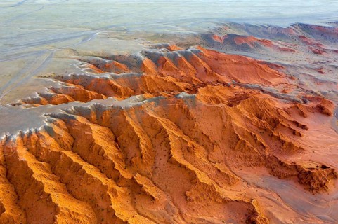 Aerial view of the Bayanzag flaming cliffs at sunset in Mongolia, found in the Gobi Desert