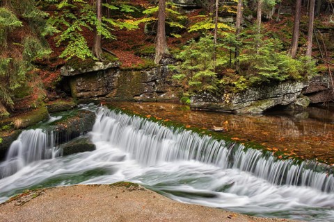 Water cascade on szklarka stream in autumn forest of Karkonoski National Park, Karkonosze