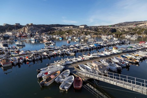 Ilulissat, Greenland, July 03, 2018: Fishing boats at Ilulissat harbor, North America