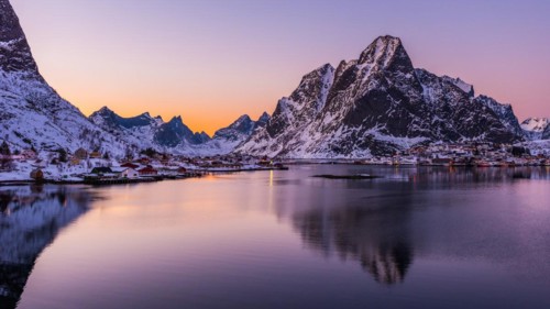 The small fishing village Reine on the Lofoten islands in Norway in winter with steep snowcapped